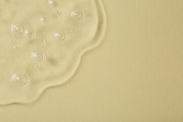 Cosmetic serum on beige background, top view. Space for text