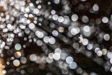 Water theme, abstract bokeh background of blurred out of focus plane water fountain droplets on...