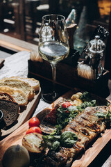 fried fish with grilled vegetables on a wooden stand, restaurant serving