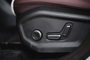 Mechanical levers at side of driver's seat for adjusting position, height and inclination. Individually regulated comfort in luxury car