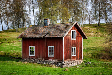 Red wooden house in Sweden sunny day