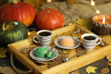 Colorful japanese sweets daifuku or mochi sliced. Sweets close up on the plate with cup of coffee