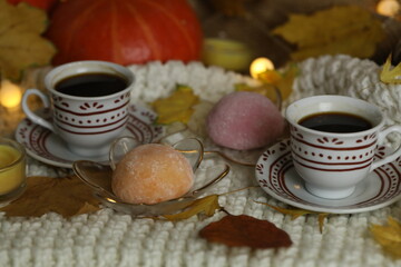Colorful japanese sweets daifuku or mochi sliced. Sweets close up on the plate with cup of coffee