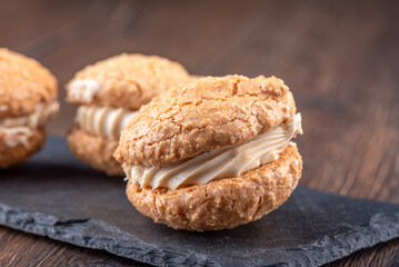 Close-up of coconut cream cookies on a mica serving board.