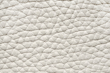 The texture of a white leather product in close-up.