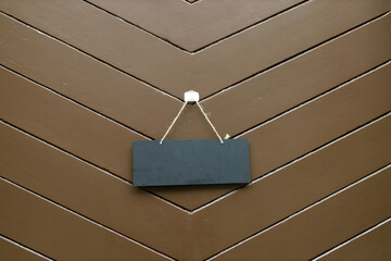 Sign decoration exterior of restaurant. Close up of black open or closed sign hanging on wooden door of cafe. Mock up