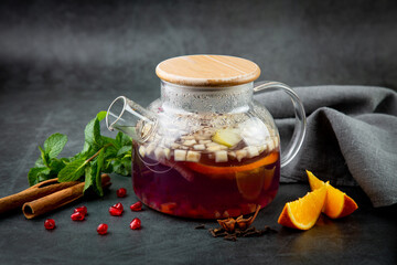 hot homemade tea with cinnamon, lemon and mint side view