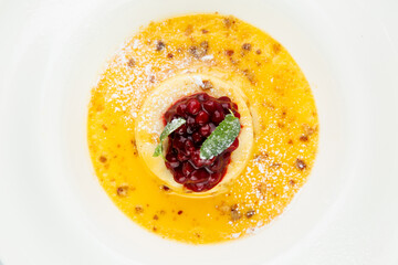 Ginger pumpkin soup with dumplings and berries. White background top view