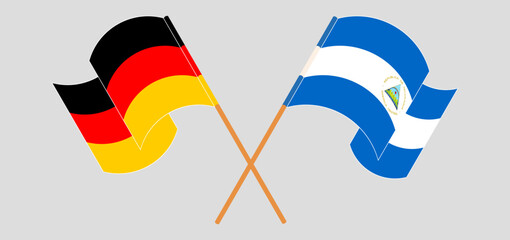 Crossed and waving flags of Germany and Nicaragua - obrazy, fototapety, plakaty
