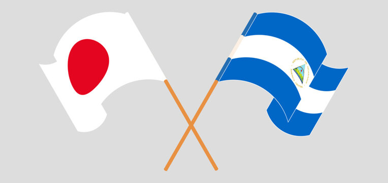Crossed and waving flags of Japan and Nicaragua