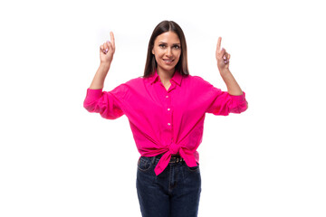 Fototapeta na wymiar young confident strong brunette woman leader wears a bright pink shirt on a white background