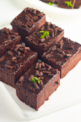 Delicious chocolate brownies with mint on white background. Sweet cake concept. 