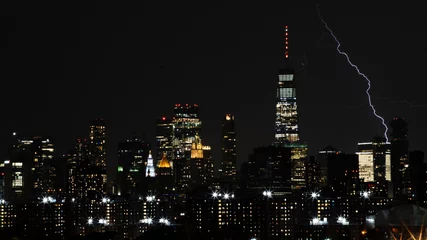 Fotobehang lightning hitting the city  © Ian