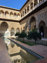 Fototapeta premium Seville, Spain, September 12, 2021: Royal Palace of Seville (Real Alcazar). The Maidens Courtyard. The Mudejar of Pedro I on the ground floor and the Renaissance of the first monarchs.