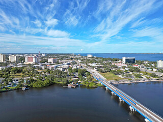 Fototapeta premium Aerial view of the newly built train tracks over Crane Creek leading to the Indian River and yacht harbor in historic downtown Melbourne along Florida's Space Coast in Brevard County