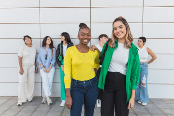 Fototapeta premium Happy diverse friends standing near wall