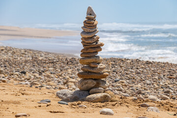 Fototapeta na wymiar Stone mount on a sandy beach in Morocco