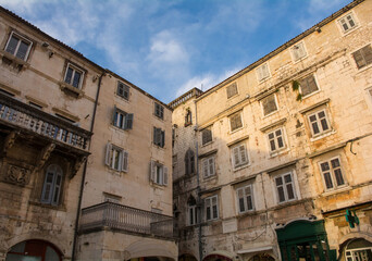 Fototapeta na wymiar Historic residential buildings above shops in Narodni Trg square in Split Old Town
