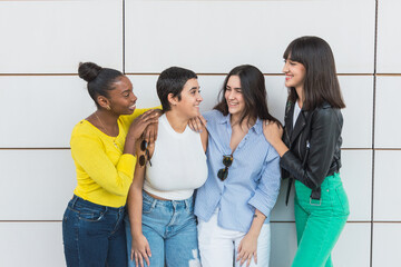 Cheerful multiethnic friends standing together on street