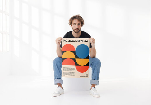 Mockup of man holding customizable vertical A2 poster in studio