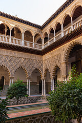 Fototapeta na wymiar Seville, Spain, September 12, 2021: The Royal Palace of Seville (Real Alcazar). The Maidens Courtyard. The Mudejar of Pedro I on the ground floor and the Renaissance of the first monarchs.