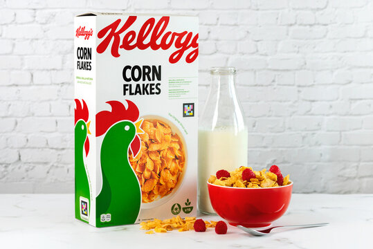 Corn Flakes Kellogg's box with a red bowl of cereal and raspberries and milk bottle