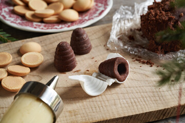Fototapeta na wymiar Preparation of beehives or wasp nests - Czech no-bake Christmas cookies filled with eggnog cream