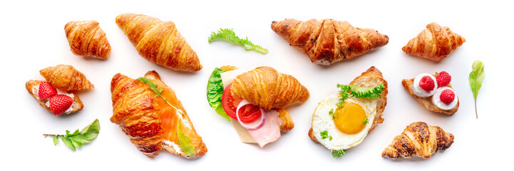 Croissant sandwich variety panorama. Different stuffed croissants, overhead flat lay shot on a white background. Rolls filled with ham, salmon, egg, etc