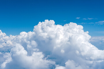 Naklejka na ściany i meble white fluffy clouds on a bright blue background.