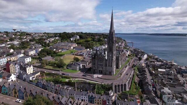 DRONE AERIAL FOOTAGE: The St. Coleman&rsquo;s Cathedral and the Deck of Cards, a gravity-defying row of candy-colored houses stacked on a vertiginous hill, in Cobh, Ireland.