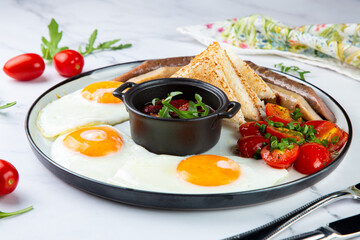 Breakfast of eggs and vegetables with cherry tomatoes and slices of bread side view