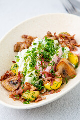 salad with potatoes, rice, meat and green onions side view