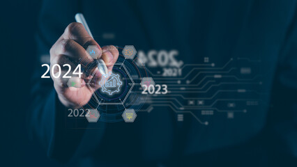 2024 Business Strategy Unveiled Businessman's Hand Reveals Goals on Virtual Screen