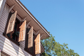 Obraz premium Wooden window with grille of wooden house