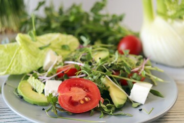 Healthy salad with microgreens, avocado, arugula and feta cheese, organic, natural ingredients.