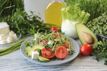Healthy salad with microgreens, avocado, arugula and feta cheese, organic, natural ingredients.