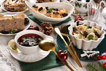 Traditional Polish Christmas Eve supper with red borscht dumplings and other dishes