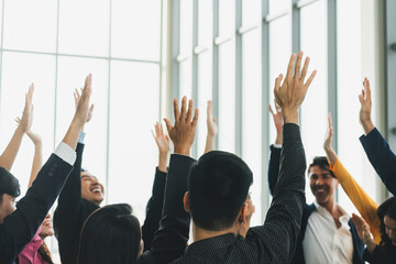 Successful business people raised their hands up for voting showing their approval volunteering in...