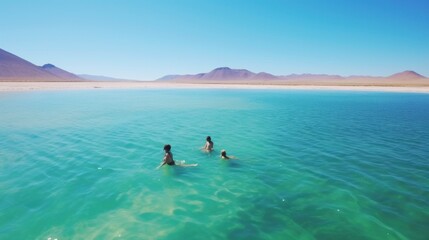 Fototapeta na wymiar people swimming in the clear blue water of the bosque de boliva