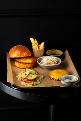 ingredients of burger with cheese on black table french fries