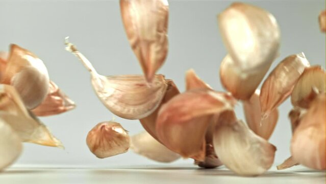 Fresh garlic falls on the table. Filmed on a high-speed camera at 1000 fps. High quality FullHD footage
