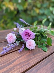 Bouquet of roses on an old wooden table