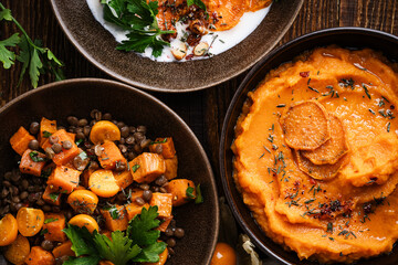 Healthy vegan meal, winter or autumn comfort food with sweet potatoes, high angle view, close up