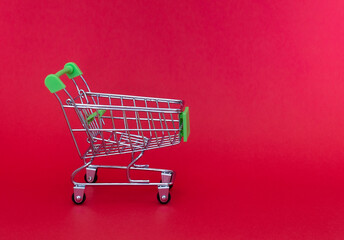 Grocery cart or shopping trolley on a red background