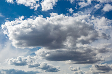 White fluffy clouds and bright sun on dark blue sky.Sky blue or azure sky and clouds is bright white background.