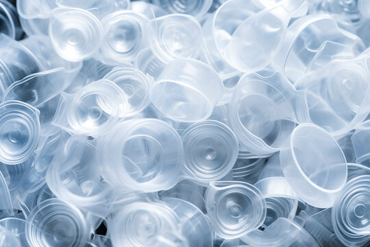 Close-up Photo Of A Pile Of Clear Plastic Cups With A Blue Tint, Stacked And Overlapping Against A Blurred Background, Ai Generative