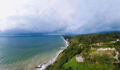 Wide aerial panoramic view. Black Sea coast flora with calm seashore in summer. the railway. Petra...