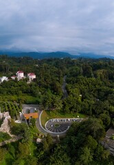 Wide aerial panoramic view scenic Black Sea coast flora with calm seashore in summer. Petra Fortress parking. Tsikhisdziri Georgia. vertical photo