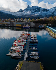 Aerial of a small island fishing town of Husoy on Senja, Norway.  A fishing village located in the...