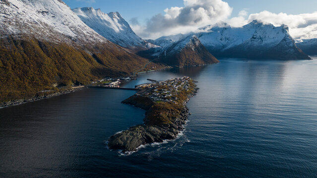 Aerial drone photo of the small island fishing town of Husoy on Senja, Norway.  A fishing village located in the Arctic Circle of Northern Norway.  Shot with a drone.